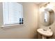 Powder room featuring a pedestal sink and stylish lighting fixture at 23201 E Orchard Pl, Aurora, CO 80015
