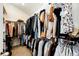 Organized walk-in closet filled with a variety of clothing provides ample storage space for an extensive wardrobe at 23201 E Orchard Pl, Aurora, CO 80015