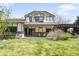Charming home featuring a well-maintained lawn and relaxing outdoor patio with yellow chairs at 1448 E Maplewood Ct, Centennial, CO 80121