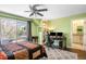 Bedroom features a ceiling fan, a work station, built-in shelving, and a sliding glass door to a balcony at 1448 E Maplewood Ct, Centennial, CO 80121