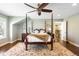 This spacious bedroom features a four-poster bed, hardwood floors, and an area rug at 1448 E Maplewood Ct, Centennial, CO 80121