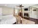 Light-filled primary bedroom boasts a fireplace, a ceiling fan, and a four-poster bed at 1448 E Maplewood Ct, Centennial, CO 80121