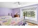 Bedroom boasts lots of light with two twin beds and a window seat at 1448 E Maplewood Ct, Centennial, CO 80121