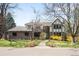 Charming two-story brick home with a manicured lawn, mature trees, and inviting curb appeal on a sunny day at 1448 E Maplewood Ct, Centennial, CO 80121