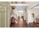 Elegant foyer featuring hardwood floors, a staircase, and views into the living spaces at 1448 E Maplewood Ct, Centennial, CO 80121