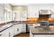 Modern kitchen featuring sleek countertops, stainless steel appliances, and ample cabinet space at 1448 E Maplewood Ct, Centennial, CO 80121