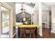 Bright dining area with a view of the cozy living room featuring a brick fireplace and white sofa at 1448 E Maplewood Ct, Centennial, CO 80121