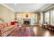 Cozy living room with a fireplace, hardwood floors, and bright natural light at 1448 E Maplewood Ct, Centennial, CO 80121