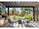 Inviting outdoor patio with pergola, fire pit, and comfortable seating for relaxing or entertaining at 1448 E Maplewood Ct, Centennial, CO 80121