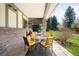 Covered patio with brick, outdoor seating and pizza oven, perfect for entertaining at 1448 E Maplewood Ct, Centennial, CO 80121