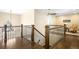 Hallway with wooden staircase and railing that leads to cozy bedrooms with large windows at 1448 E Maplewood Ct, Centennial, CO 80121