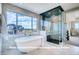 Spa-like bathroom with large soaking tub, walk-in shower, and modern fixtures at 1055 Greens Pl, Erie, CO 80516