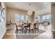 Elegant dining room featuring modern chandelier, stylish chairs, and view to backyard at 1055 Greens Pl, Erie, CO 80516