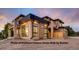 Beautiful home with a stone accent wall, a metal roof, and a balcony in a picturesque neighborhood at 1055 Greens Pl, Erie, CO 80516