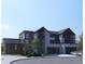 Contemporary home showcases clean lines, stone accents, a two-car garage, and modern design elements at 1055 Greens Pl, Erie, CO 80516