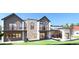 Stunning modern home featuring a stone facade, multiple balconies, and expansive windows providing ample natural light at 1055 Greens Pl, Erie, CO 80516