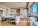 Spacious kitchen featuring a large center island, stainless steel appliances, and modern pendant lights at 1055 Greens Pl, Erie, CO 80516