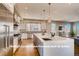 Gourmet kitchen with expansive island, stainless steel appliances, and white cabinets at 1055 Greens Pl, Erie, CO 80516