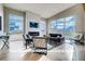 Bright living room featuring high ceilings, a fireplace with marble surround, and large windows at 1055 Greens Pl, Erie, CO 80516