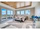 Bright main bedroom with wood ceiling, an outdoor balcony, and large windows with scenic views at 1055 Greens Pl, Erie, CO 80516