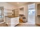 Spacious walk-in closet with custom shelving and storage, plus a view into a spa-like bathroom at 1055 Greens Pl, Erie, CO 80516