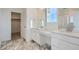 Double vanity bathroom with marble-look floors and walk-in shower at 196 Kino Ct, Brighton, CO 80601