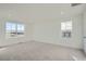 Spacious bedroom with two windows and light gray carpeting at 196 Kino Ct, Brighton, CO 80601