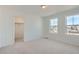 Bright bedroom with two windows and light gray carpeting at 196 Kino Ct, Brighton, CO 80601