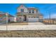 Two-story house with solar panels, attached garage, and landscaping at 196 Kino Ct, Brighton, CO 80601