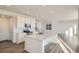 Open concept kitchen with white cabinets, quartz countertops, and an island at 196 Kino Ct, Brighton, CO 80601