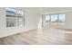 Bright living room with large windows and light wood-look floors at 196 Kino Ct, Brighton, CO 80601