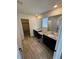 Bathroom with dual sinks, granite countertops, and a large mirror at 914 Peach Leaf Ln, Elizabeth, CO 80107