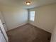 Small, simple bedroom with neutral walls and carpet, plus a window and closet access at 914 Peach Leaf Ln, Elizabeth, CO 80107