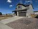 Two-story home with an attached two-car garage and a driveway, complemented by decorative rock landscaping at 914 Peach Leaf Ln, Elizabeth, CO 80107