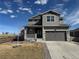 Charming two-story home featuring a covered porch, two-car garage, and meticulous landscaping at 914 Peach Leaf Ln, Elizabeth, CO 80107