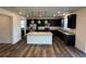 Spacious kitchen with a large island, dark cabinetry, granite countertops, and stainless steel appliances at 914 Peach Leaf Ln, Elizabeth, CO 80107