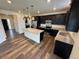 Stylish kitchen with granite countertops, dark cabinets, and stainless steel appliances with an island at 914 Peach Leaf Ln, Elizabeth, CO 80107