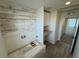 Functional laundry room with built-in shelving and wood accent wall at 914 Peach Leaf Ln, Elizabeth, CO 80107