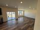 Bright living room with wood floors and sliding glass doors to backyard at 914 Peach Leaf Ln, Elizabeth, CO 80107
