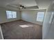 Large main bedroom with tray ceiling, ceiling fan, and bright windows at 914 Peach Leaf Ln, Elizabeth, CO 80107