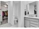 Elegant bathroom with a modern vanity, toilet, and a view into a walk-in closet, offering style and convenience at 22472 E Narrowleaf Cir, Aurora, CO 80016