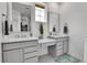 Modern bathroom featuring dual sinks with plenty of counter space and natural light from the windows at 22472 E Narrowleaf Cir, Aurora, CO 80016