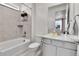 Well-lit bathroom featuring a tub-shower combination, toilet, and a sleek vanity with modern fixtures and finishes at 22472 E Narrowleaf Cir, Aurora, CO 80016