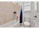 Bright bathroom with a tub-shower featuring tiled walls and a shower curtain, plus a toilet, ensuring a clean space at 22472 E Narrowleaf Cir, Aurora, CO 80016