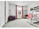 Bright bedroom featuring a large window, a cozy beanbag chair, and a playful loft bed setup, ideal for  at 22472 E Narrowleaf Cir, Aurora, CO 80016