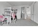 Spacious bedroom with loft bed, desk, and view to upstairs bath providing a versatile and functional space at 22472 E Narrowleaf Cir, Aurora, CO 80016