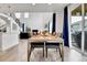 Open-concept dining area showcasing high ceilings, abundant natural light, and sliding door to outdoor space at 22472 E Narrowleaf Cir, Aurora, CO 80016