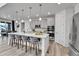 Modern kitchen with a large island, stainless steel appliances, and a dining area in an open layout at 22472 E Narrowleaf Cir, Aurora, CO 80016