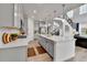 Bright kitchen with an island, stainless steel appliances, and a view of the staircase and living room at 22472 E Narrowleaf Cir, Aurora, CO 80016
