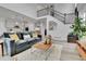 Stylish living room with an open floor plan, hardwood floors, and contemporary furniture at 22472 E Narrowleaf Cir, Aurora, CO 80016